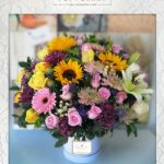 caja en girasoles, gérberas y lirios
